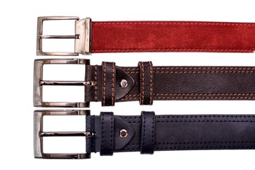 Several fashionable male belts red gray brown isolated on white background