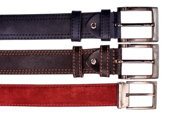 Several fashionable male belts red gray brown isolated on white background
