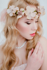 picture of young blonde woman wearing wreath of flowers, spring tender and romantic portrait, fashion retouched shot