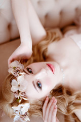 Naklejka premium picture of young blonde woman wearing wreath of flowers, spring tender and romantic portrait, fashion retouched shot