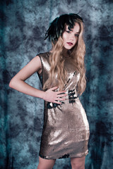 Fototapeta premium Attractive young woman posing in sequin dress. Studio image
