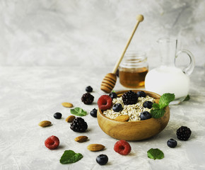Healthy breakfast with oat flakes, raspberry berries, blueberries, selective focus