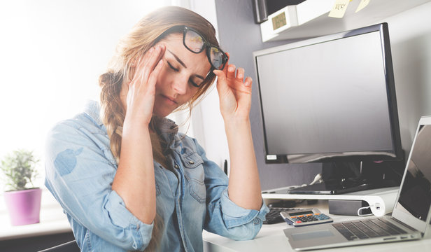 Stressed tired woman working at home office concept of problems