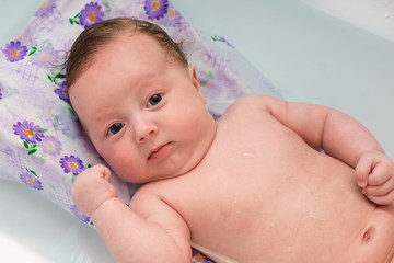 The baby is bathed in the bathroom