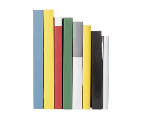 Pile of colorful books in a line. All names and titles removed from the spines. 