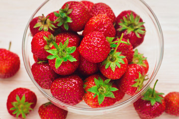 Red strawberry in bowl.