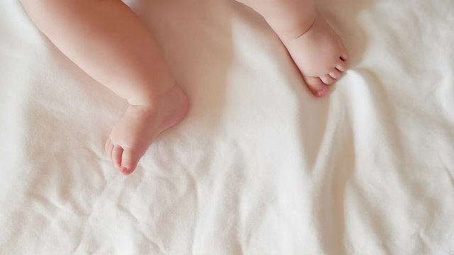 Two little feet a newborn baby On a white background. Full HD 1080p
