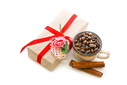 Box with a gift and coffee beans in a cup