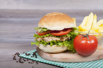 Homemade budrger chicken with french fries, tomato and lettuce