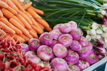 Turnips and carrots on farmer market in Paris, France