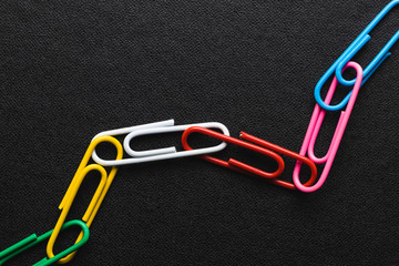 Chain made of paper clips on black background,teamwork and success concept. - 161874841
