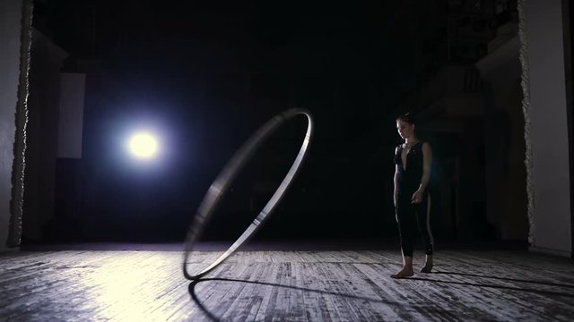 Circus artist training with a big hula hoop