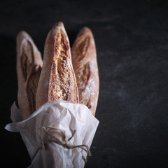 Three freshly baked baguettes on the table.