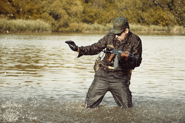 Action soldier in uniform attacking with assault rifle