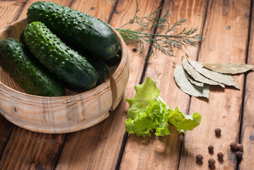 Cucumbers for preservation in wooden utensils.