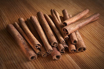 Cinnamon sticks on wooden background