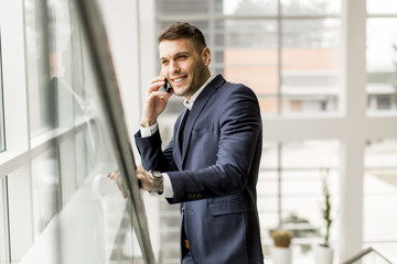 Handsome  businessman in classic suit  talking on mobile phone