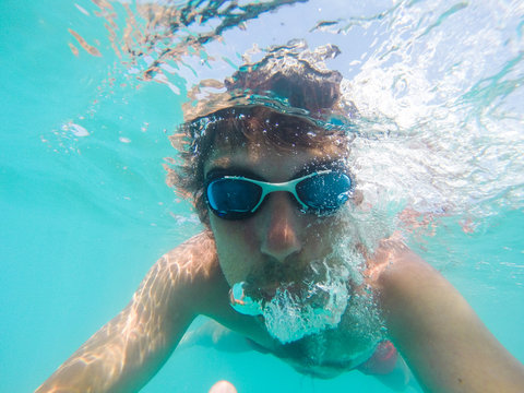 Underwater view of a man swimming in the sea