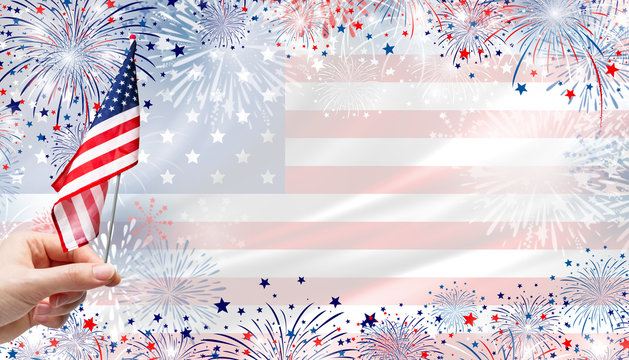 Woman hand holding USA flag on fireworks background for 4 july independence day