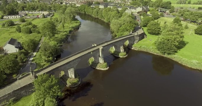 4k aerial footage of the Old Stirling Bridge on a bright sunny day.