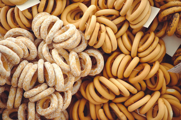 Closeup of a group of different donuts on a street sale with burlap in the background