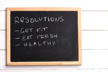 Obraz premium Blackboard with written checklist of resolutions