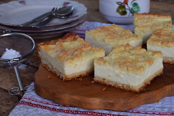 Homemade cottage cheese pie. Rustic grated cake bars on a wooden board