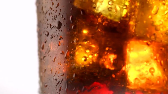 Coke with ice cubes background. Rotation 360 degrees. 4K UHD video 3840X2160