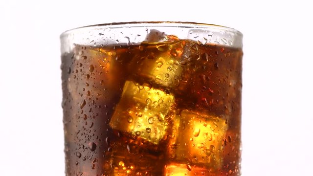 Coke with ice cubes background. Rotation 360 degrees. 4K UHD video 3840X2160