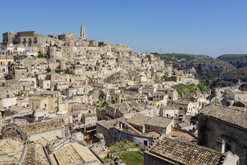 Fototapeta na wymiar amazing panorama view of ancient ghost town of Matera (Sassi di Matera) in bright sun shine summer with blue sky, south Italy