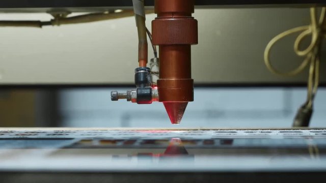 cnc Laser cutting machine at work. Acrylic plastic cutting. Close-up