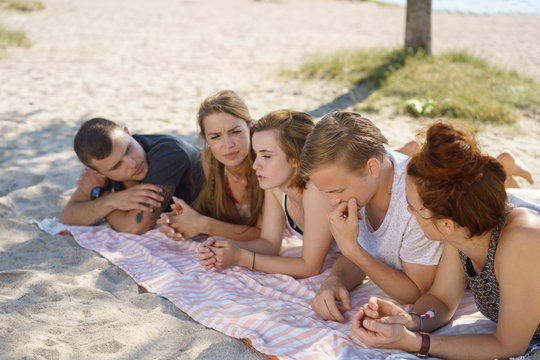 Group of young people relaxing on the beach