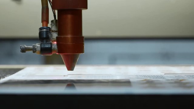 cnc Laser cutting machine at work. Acrylic plastic cutting. Close-up
