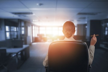 Composite image of rear view of business executive holding cigar