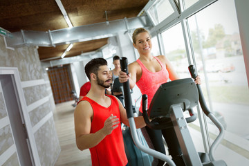 Attractive woman working cardio exercises with trainer