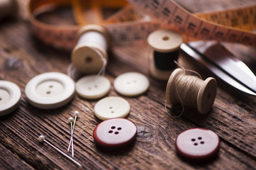 Sewing accessories on wooden background