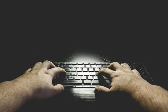 Hands In The Dark Typing On Keyboard. Black Copy Space