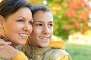 Obraz premium Mother and son hugging outdoors