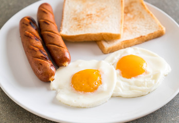fried eggs with sausage and bread