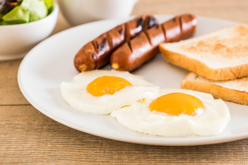 fried eggs with sausage and bread