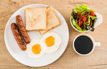 fried eggs with sausage and bread