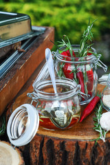 Red pepper and rosemary in glass jar