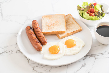 fried eggs with sausage and bread