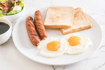fried eggs with sausage and bread