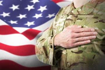 Composite image of mid section of soldier in uniform taking oath