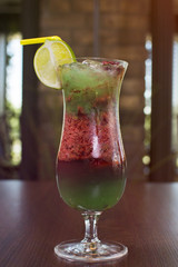 Alcohol bar, cocktail glass on the bar counter, cocktail glass in a bar. Drinking cocktails. Fresh drink cocktail on a color background.