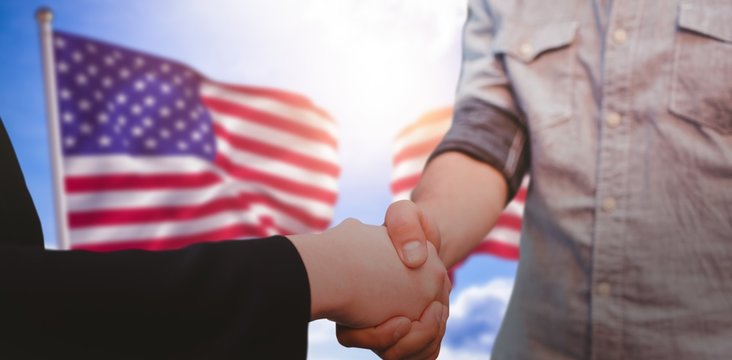 Composite image of corporate man and woman shaking hands