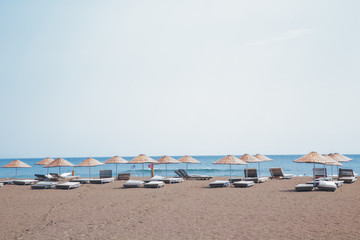 Fototapeta na wymiar Beach umbrellas by the sea