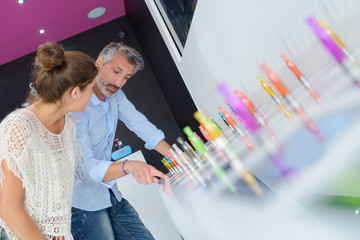 shop assistant showing vaporiser to customer