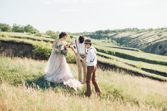 wedding photographer takes pictures of bride and groom in nature, fine art photo